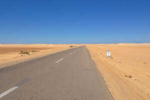 砂漠の中を真っすぐに伸び、ダクラへ向かう道